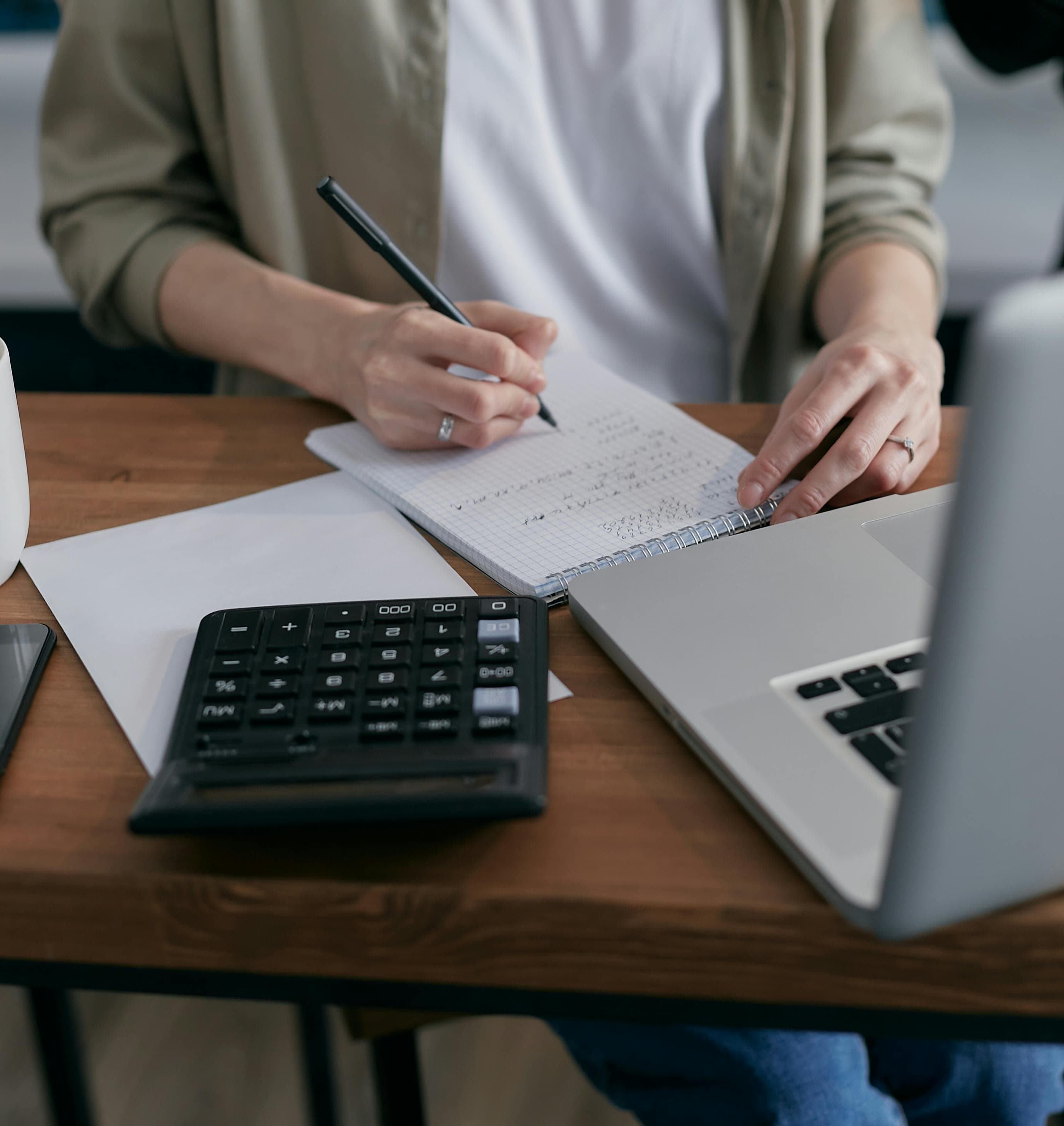 A professional bookkeeper working on a laptop